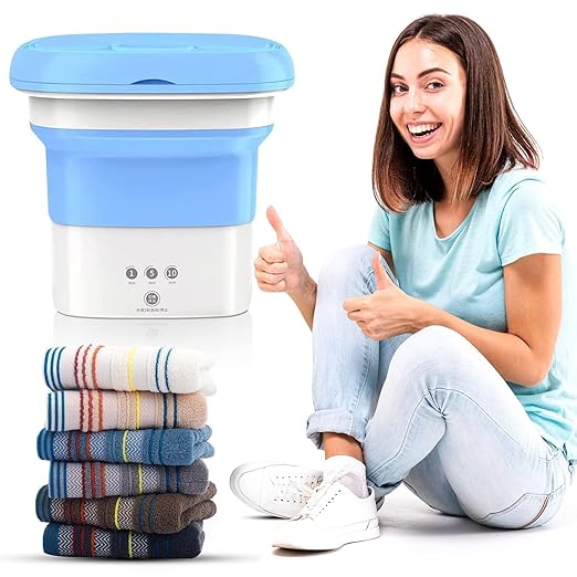 Portable foldable mini washing machine with laundry basket and clean folded clothes for travel and home use.